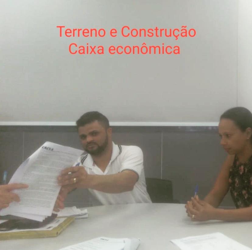 Cliente recebendo o contrato de terreno e construção na Caixa